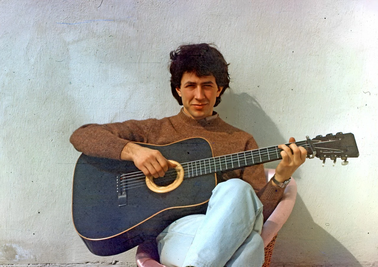 Rafal Turkowiak as a young man, seated with a guitar from the family archive