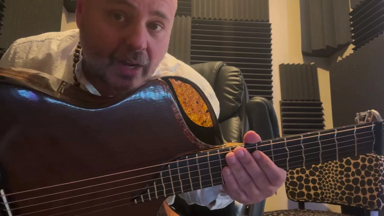 Andy McKee with his Turkowiak Driftfire Grand Auditorium in his studio